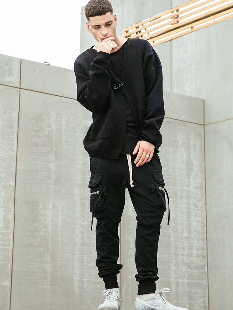 Man  in black cargo pants standing on a wall in an urban environment